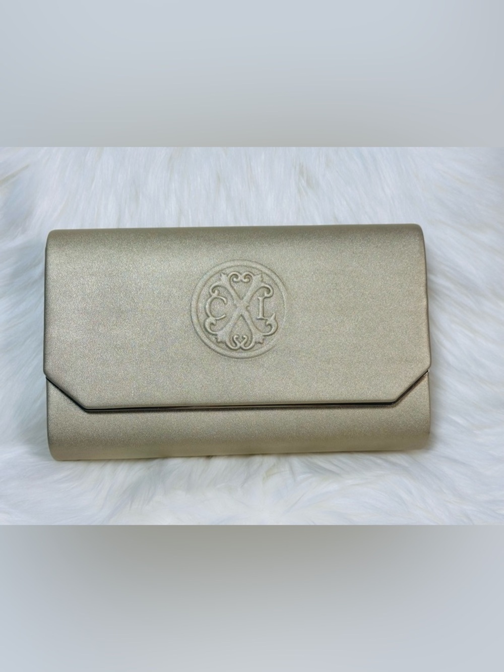 CXL by Christian Lacroix Madison Smooth Clutch is a gold-colored evening bag